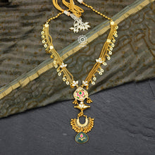Make a sophisticated style statement with this elegant silver neckpiece. Necklace crafted using traditional techniques with dainty gold polish chain including kundan work floral motifs, tribal amulet and green semi precious stone drop. Perfect for intimate weddings and upcoming festive celebrations.
