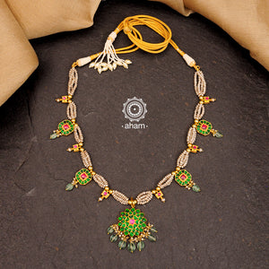 Handcrafted festive neckpiece with green floral motifs, semi precious stones converted into beads and cultured pearls. Lightweight and elegant necklace perfect for family functions and special occasions. 