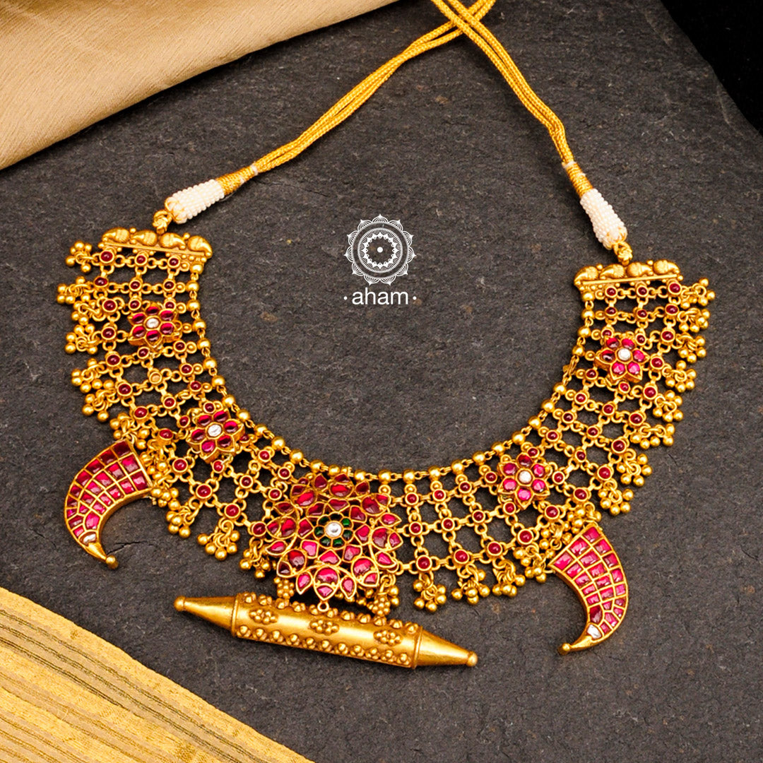 Handcrafted tiger claw neckpiece with a temple amulet pendant in the centre. Created using traditional techniques in 92.5 sterling silver with gold polish, rani (pink) coloured stone floral motifs and statement ghungroos. Perfect for intimate weddings and upcoming festive celebrations.