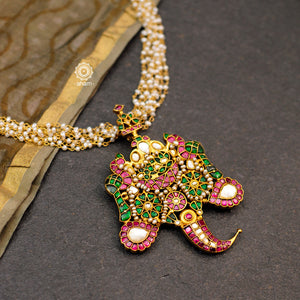 Make a sophisticated style statement with this gold polish double peacock neckpiece. Handcrafted using traditional techniques in silver with kundan work, elephant motifs and cultured pearls. Perfect for intimate weddings and upcoming festive celebrations.  