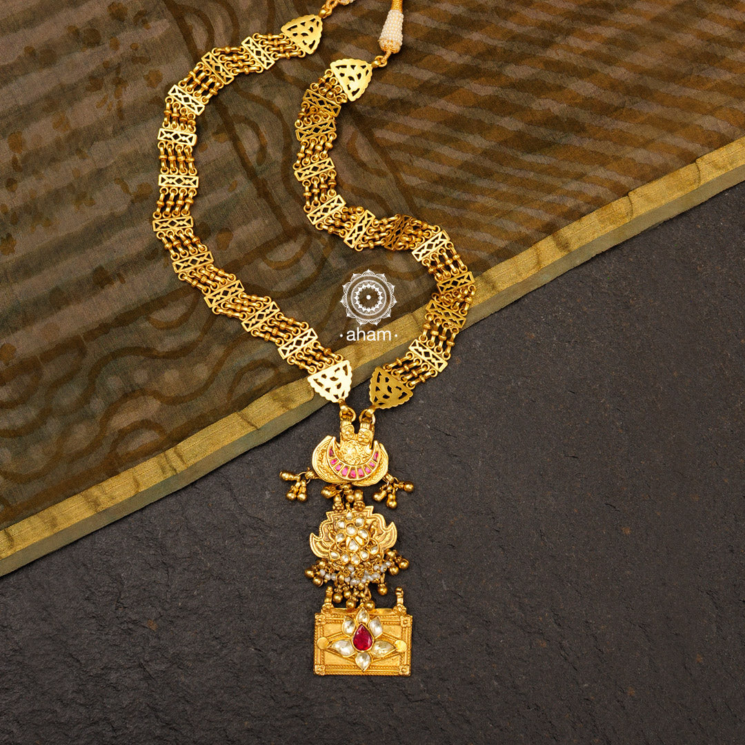 Classic gold polish neckpiece handcrafted using traditional techniques in 92.5 sterling silver with kundan highlights and cultured pearls. Perfect for intimate weddings and upcoming festive celebrations. 