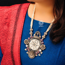 Make a charming appearance with this one of a kind cultured pearl mala neckpiece with elegant dancing peacock and blooming flower motifs. Handcrafted in 92.5 sterling silver with maroon kemp stone highlights and semi precious moonstone. Perfect for special occasions.