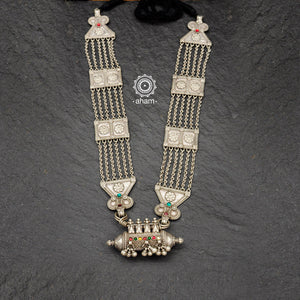Tribal silver multi line neckpiece with flower work silver pieces in between and a beautiful amulet pendant. This necklace truly exemplifies the continuity of the traditional prototypes.