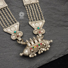 Tribal silver multi line neckpiece with flower work silver pieces in between and a beautiful amulet pendant. This necklace truly exemplifies the continuity of the traditional prototypes.