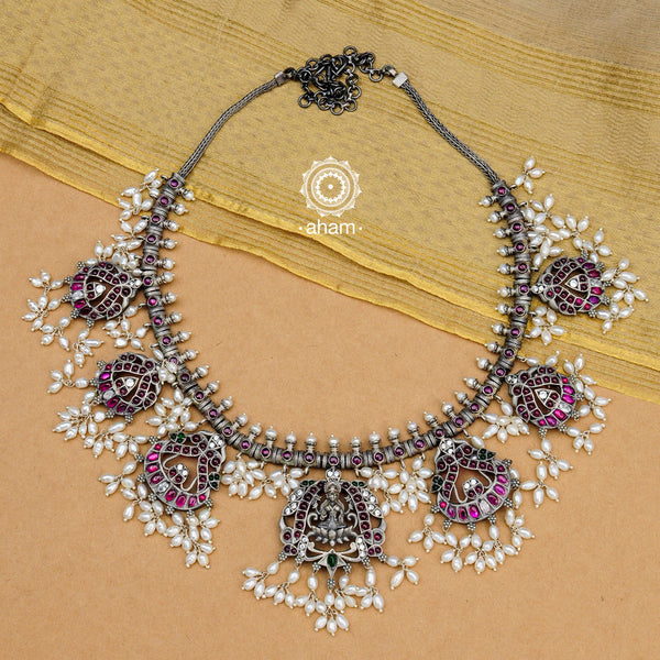 Beautiful handcrafted Guttapusalu style goddess Lakshmi neckpiece. Created in 92.5 sterling silver with intricate peacock motifs, green and maroon Kemp stone setting.    Gutta in Telugu means “Shoals of small fish”, and Pusalu means “beads”. Set in a melange of kundan, green and kemp stones fringed with bunches of small pearls, the Guttapusalu are a most have in every jewellery lovers collection. These are timeless pieces for generations to come.