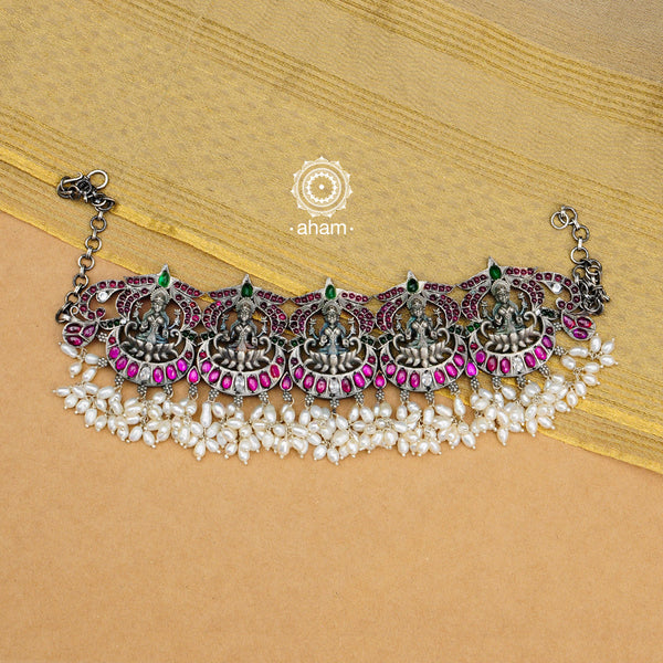 Beautiful handcrafted Guttapusalu style goddess Lakshmi choker. Created in 92.5 sterling silver with green and maroon Kemp stone setting.    Gutta in Telugu means “Shoals of small fish”, and Pusalu means “beads”. Set in a melange of kundan, green and kemp stones fringed with bunches of small pearls, the Guttapusalu are a most have in every jewellery lovers collection. These are timeless pieces for generations to come.