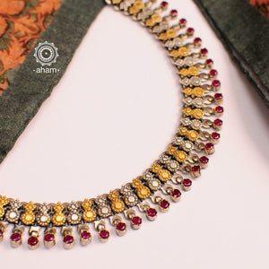 Flaunt beautiful Noori two tone short neckpiece. Handcrafted in 92.5 sterling silver with maroon semi precious stones. An elegant piece perfect for special occasions and family gatherings.