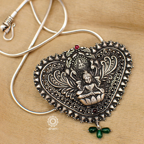 Goddess Lakshmi peacock pendant with intricate Nakshi work. Handcrafted by skillful artisans in 92.5 sterling silver. Inspired from South Indian temple work.