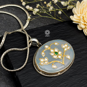 Handmade pendant with Mughal Inspired intricate floral inlay work in semi precious stone setting, encased in silver. Wear it long or short with a chain of your choice, or a smart silver Hasli. A piece so timeless that it can we worn across generations.  Please note, each piece created in this series is unique and one of a kind. 