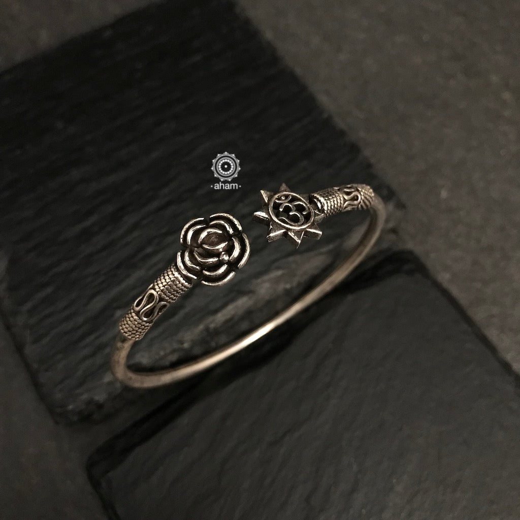 Handcrafted twist and wear bracelets in 92.5 sterling silver with beautiful flower and Om motif. Statement accessory which look great paired with your watches or even by itself.