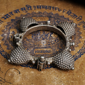 Vintage silver kada with intricate work, handcrafted by skilful artisans. Beautiful piece from a bygone era, that bring back memories and stories of that time.  The Naugari Kada is a two part bracelet with projected simulated gajre balls made from stamped silver sheet.  The price is for one piece only. 