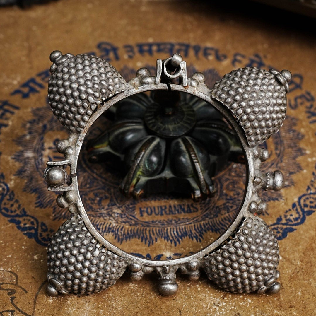 Vintage silver kada with intricate work, handcrafted by skilful artisans. Beautiful piece from a bygone era, that bring back memories and stories of that time.  The Naugari Kada is a two part bracelet with projected simulated gajre balls made from stamped silver sheet.  The price is for one piece only. 