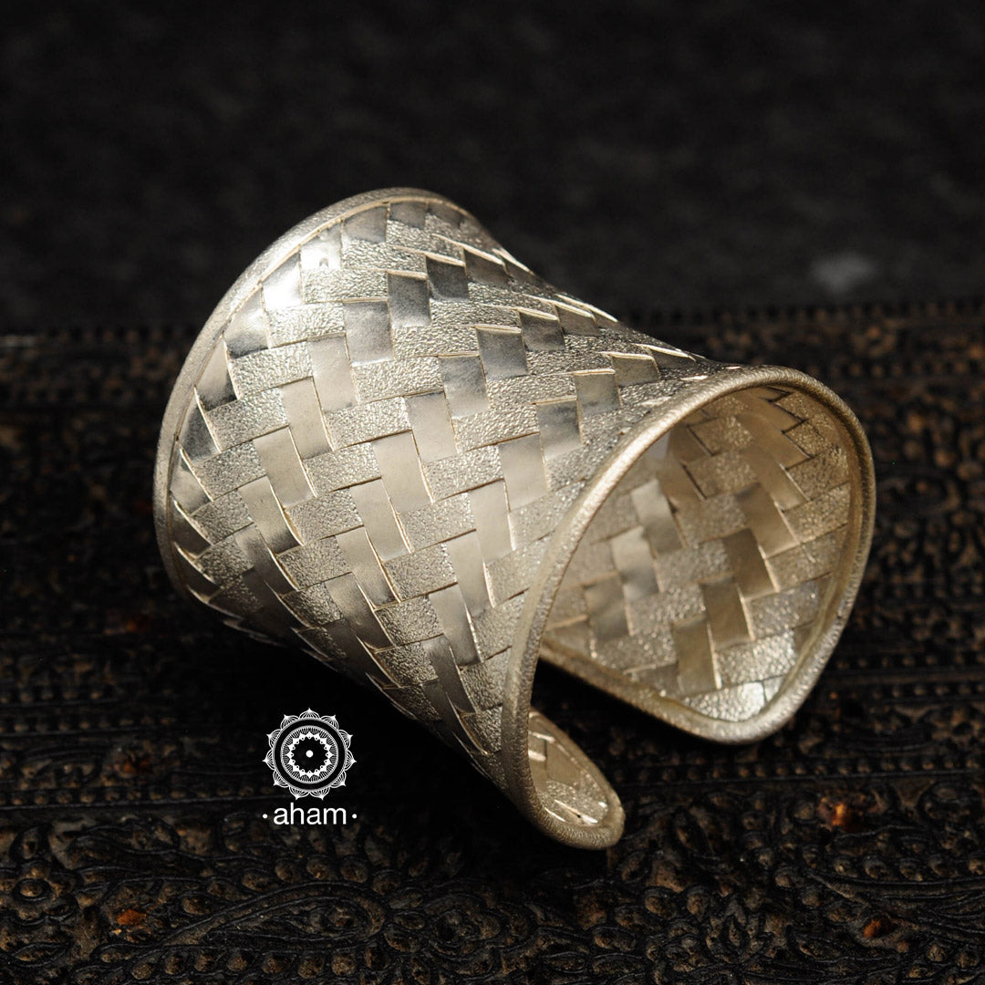 Adjustable 92.5 sterling silver handcuff with intricate weave pattern.
