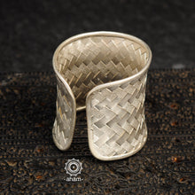 Adjustable 92.5 sterling silver handcuff with intricate weave pattern.
