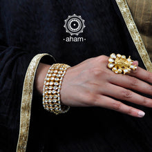 Handcrafted festive gold polish bracelet in 92.5 sterling silver with kundan work and embellished cultured pearls.