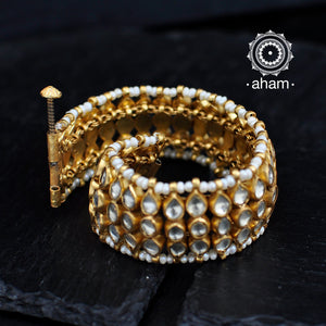 Handcrafted festive gold polish bracelet in 92.5 sterling silver with kundan work and embellished cultured pearls.