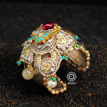 Noori two tone silver open hand cuff with a vibrant bird motif. An eclectic mix of elements, with a play of colours, textures, forms and workmanship. Handcrafted in 92.5 sterling silver with dual tones that make them so versatile and unique. Modern Heirloom pieces that can be worn across generations. 