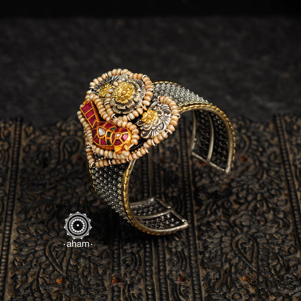Noori two tone silver open hand cuff with a vibrant bird motif. An eclectic mix of elements, with a play of colours, textures, forms and workmanship. Handcrafted in 92.5 sterling silver with dual tones that make them so versatile and unique. Modern Heirloom pieces that can be worn across generations. 