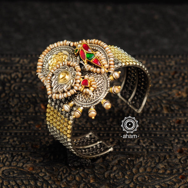 Noori two tone silver open hand cuff with a vibrant bird motif. An eclectic mix of elements, with a play of colours, textures, forms and workmanship. Handcrafted in 92.5 Sterling Silver with two tones that make them so versatile and unique. Modern Heirloom pieces that can be worn across generations. 