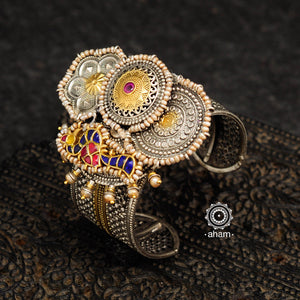 Noori two tone silver open hand cuff with a vibrant peacock motif. An eclectic mix of elements, with a play of colours, textures, forms and workmanship. Handcrafted in 92.5 Sterling Silver with two tones that make them so versatile and unique. Modern Heirloom pieces that can be worn across generations. 