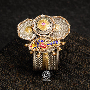 Noori two tone silver open hand cuff with a vibrant peacock motif. An eclectic mix of elements, with a play of colours, textures, forms and workmanship. Handcrafted in 92.5 Sterling Silver with two tones that make them so versatile and unique. Modern Heirloom pieces that can be worn across generations. 