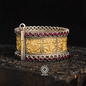 Beautiful two tone kada with floral motifs and maroon stone highlights The price is for one piece kada only.