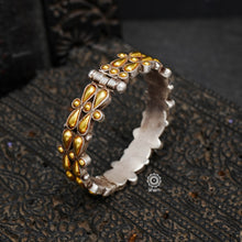 Noori two tone hand kada handcrafted in 92.5 sterling silver with intricate floral work. The beauty of two tone jewellery pieces is that they are so versatile, they can be clubbed and styled with so many outfits, including your Indian and Western wear.