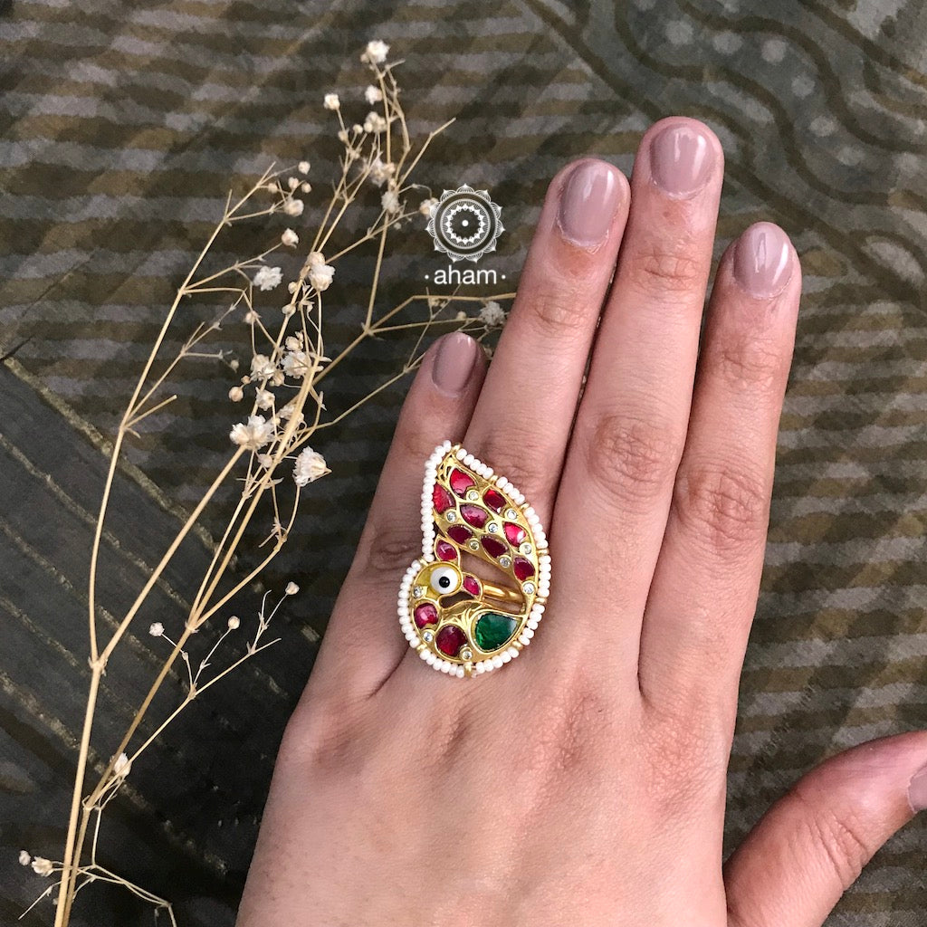 Gold polish peacock ring with cultured pearls. Beautiful adjustable ring crafted in 92.5 sterling silver with kundan work. Perfect for special occasions and festivities. 