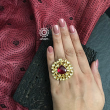 Gold polish adjustable ring with kundan stone setting. Handcrafted in 92.5 sterling silver with red semi precious stone drop. Perfect for special occasions and festivities. 