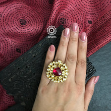 Gold polish adjustable ring with kundan stone setting. Handcrafted in 92.5 sterling silver with red semi precious stone drop. Perfect for special occasions and festivities. 