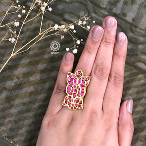 Festive gold polish adjustable ring with rani pink kundan work. Handcrafted in 92.5 sterling silver with elegant geometric designs. Perfect for special occasions and festivities. 