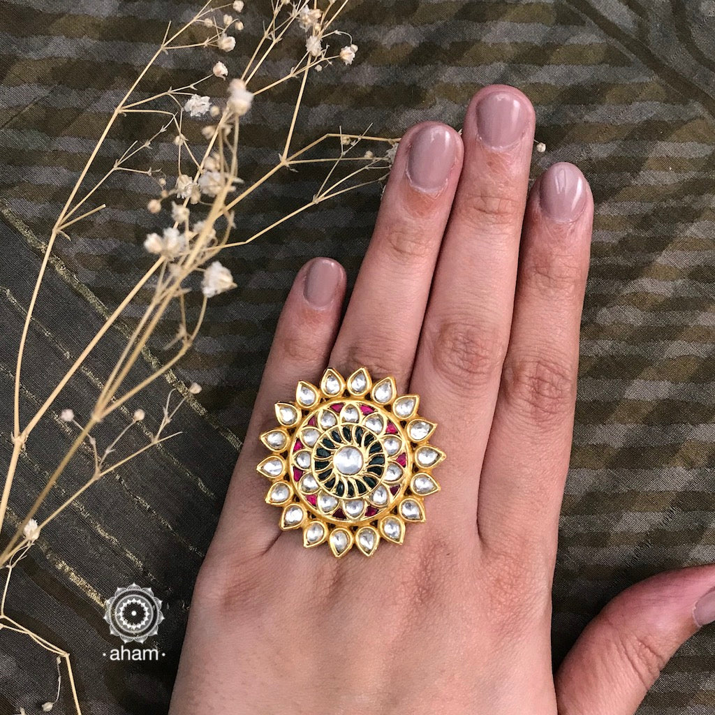 Festive gold polish adjustable ring including green pink kundan work. Handcrafted in 92.5 sterling silver with elegant geometric designs. Perfect for special occasions and festivities. 