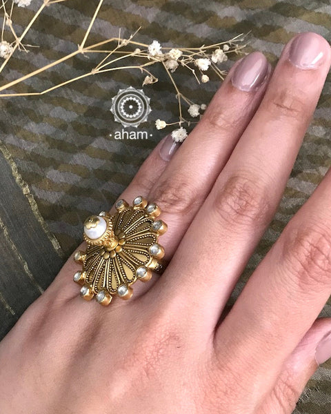 Festive gold polish adjustable ring including elegant kundan work. Handcrafted in 92.5 sterling silver with 3D cultured pearl crown. Perfect for special occasions and festivities. 