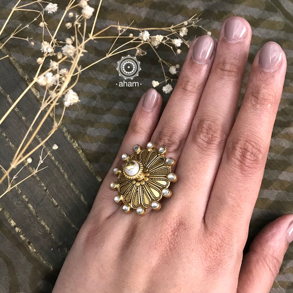 Festive gold polish adjustable ring including elegant kundan work. Handcrafted in 92.5 sterling silver with 3D cultured pearl crown. Perfect for special occasions and festivities. 