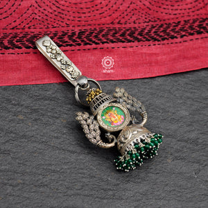 Hand painted Ganesha key chain. Handcrafted in 92.5 sterling silver with elegant peacock motifs and semi precious green beads dangling on a chitai work jhumka. Also known as Challah, Juda, Chatka and Guchha 