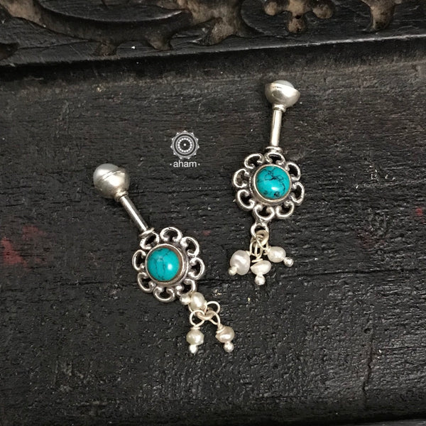 Handcrafted silver flower Bugadi with turquoise stone and hanging pearls. Please note the dimensions before you buy.  We do not allow any exchanges on account of size of the bugadi.   Bugudi in Karnataka. Bugadi in Maharashtra.  Koppu in Tamil Nadu.   Is Worn in the Helix. 