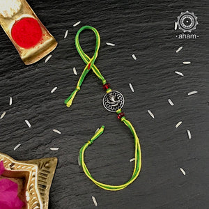 Beautiful Silver Rakhi, Make this Rakshabandhan Memorable with this handcrafted Rakhi  Silver dial weaved with cotton thread for an ever-lasting Knot.  Roli and Akshat (kumkum chawal) shipped along with India orders only.  Tip: you can later convert this into a key chain charm or a pendant as well