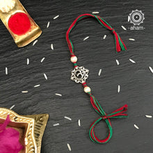 Easy to tie,  Elegant Om Rakhi in 925 sterling silver for your brother weaved in Red and Green Colour cotton thread . Traditional Handcrafted 925 Silver rakhi. Also avaialble  Rakhi made with Ganapati and Trishul  symbol. Starting with Rs.  551,  wide range of silver rakhi , 50+ rakhi designs. Gift for Sister. worldwide Shipping. Buy 925  Sterling Silver Rakhi Collection Online India.  Shop Now.
