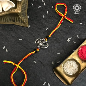 Beautiful Silver Rakhi, Make this Rakshabandhan Memorable with this handcrafted Rakhi  Silver dial weaved with cotton thread for an ever-lasting Knot.  Shagun of Roli (kumkum), Akshat (Chawal) and mishri (Sugar) is shipped along with each individual rakhi  (India orders only)  Tip: you can later convert this into a key chain charm or a pendant as well