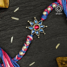 Easy to tie,  Elegant Floral motif in 925 sterling silver rakhi for your brother weaved in Blue and Pink Colour cotton thread and pearls.Traditional Handcrafted 925 Silver rakhi. Also avaialble  Rakhi made with Ganapati, Trishul  and Om symbol. Starting with Rs.  551,  wide range of silver rakhi , 50+ rakhi designs. Gift for Sister. worldwide Shipping. Buy 925  Sterling Silver Rakhi Collection Online India.  Shop Now.