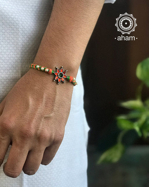Easy to tie, Elegant Floral Motif Silver Rakhi in 925 sterling silver for your brother weaved in Orange and Green Colour cotton thread and Pearls. Traditional Handcrafted 925 Silver rakhi. Also avaialble Rakhi made with Ganapati, Trishul and Om symbol. Starting with Rs. 551, wide range of silver rakhi , 50+ rakhi designs. Gift for Sister. worldwide Shipping. Buy 925 Sterling Silver Rakhi Collection Online India. Shop Now.