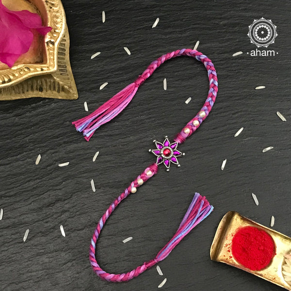 Easy to tie,  Elegant Flower motif in 925 sterling silver rakhi for your brother weaved in Pink and Purple colour cotton thread and Pearls.. Traditional Handcrafted 925 Silver rakhi. Also avaialble  Rakhi made with Ganapati, Trishul  and Om symbol. Starting with Rs.  551,  wide range of silver rakhi , 50+ rakhi designs. Gift for Sister. worldwide Shipping. Buy 925  Sterling Silver Rakhi Collection Online India.  Shop Now.