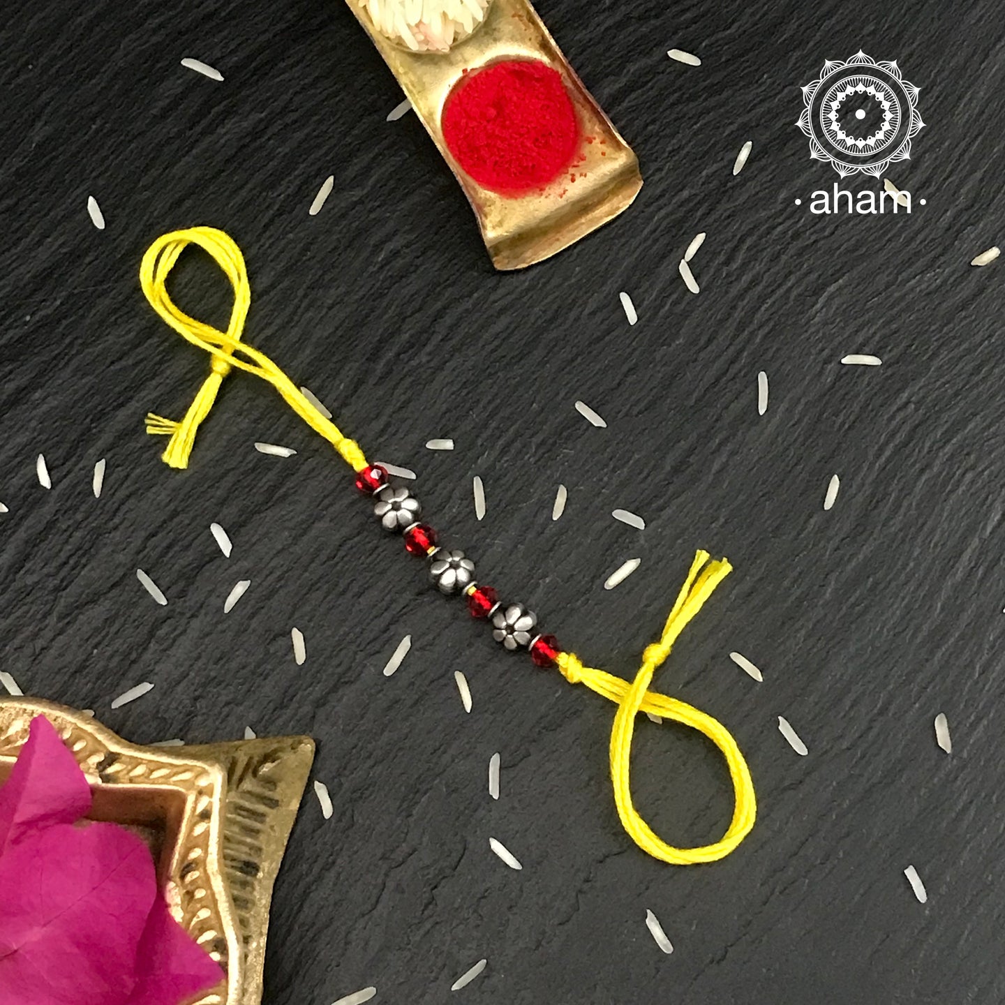 Easy to tie,  Elegant Silver Flower Beads rakhi in 925 sterling silver for your brother weaved in Yellow colour cotton thread . Traditional Handcrafted 925 Silver rakhi. Also avaialble  Rakhi made with Ganapati, Trishul  and Om symbol. Starting with Rs.  551,  wide range of silver rakhi , 50+ rakhi designs. Gift for Sister. worldwide Shipping. Buy 925  Sterling Silver Rakhi Collection Online India.  Shop Now.