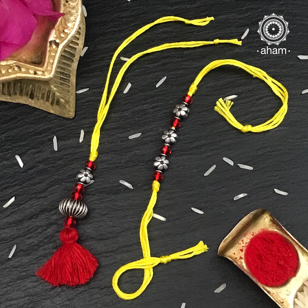 Easy to tie,  Elegant Floral Beads Rakhi and Lumba Set in 925 sterling silver  for your Bhaiya and Bhabhi weaved in Yellow Colour cotton thread . Traditional Handcrafted 925 Silver rakhi. Also avaialble  Rakhi made with Ganapati, Trishul  and Om symbol. Starting with Rs.  551,  wide range of silver rakhi , 50+ rakhi designs. Gift for Sister. worldwide Shipping. Buy 925  Sterling Silver Rakhi Collection Online India.  Shop Now.