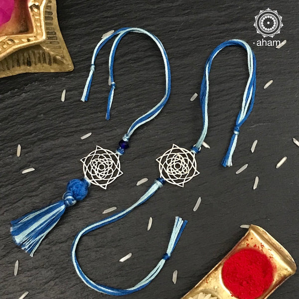 Easy to tie,  Elegant Mandla Rakhi and Lumba Set in 925 sterling silver for your Bhaiya and Bhabhi weaved in Blue colour cotton thread . Traditional Handcrafted 925 Silver rakhi. Also avaialble  Rakhi made with Ganapati, Trishul  and Om symbol. Starting with Rs.  551,  wide range of silver rakhi , 50+ rakhi designs. Gift for Sister. worldwide Shipping. Buy 925  Sterling Silver Rakhi Collection Online India.  Shop Now.