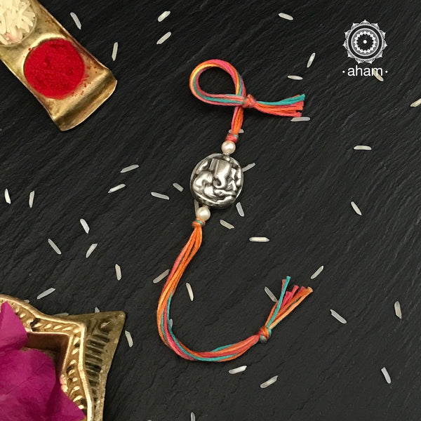 Easy to tie,  Elegant Ganesh Symbol Rakhi in 925 sterling silver for your brother weaved in Multi Colour cotton thread . Traditional Handcrafted 925 Silver rakhi. Also avaialble  Rakhi made with Ganapati, Trishul  and Om symbol. Starting with Rs.  551,  wide range of silver rakhi , 50+ rakhi designs. Gift for Sister. worldwide Shipping. Buy 925  Sterling Silver Rakhi Collection Online India.  Shop Now.