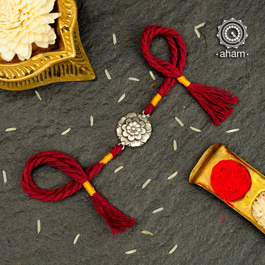 Easy to tie,  Elegant Floral motif in 925 sterling silver rakhi for your brother weaved in Maroon and Yellow colour cotton thread . Traditional Handcrafted 925 Silver rakhi. Also avaialble  Rakhi made with Ganapati, Trishul  and Om symbol. Starting with Rs.  551,  wide range of silver rakhi , 50+ rakhi designs. Gift for Sister. worldwide Shipping. Buy 925  Sterling Silver Rakhi Collection Online India.  Shop Now.