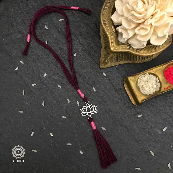Beautiful Silver Lumba for Bhabhi. Make this Rakshabandhan Memorable with this handcrafted Lumba with an ever-lasting Knot.  Elegant Lotus Symbol 925 Silver dial weaved with purple colour cotton thread.   Tip: you can later convert this into a key chain charm or a pendant as well  Roli (kumkum), Akshat (Chawal) and  Mishri shipped along with India orders only