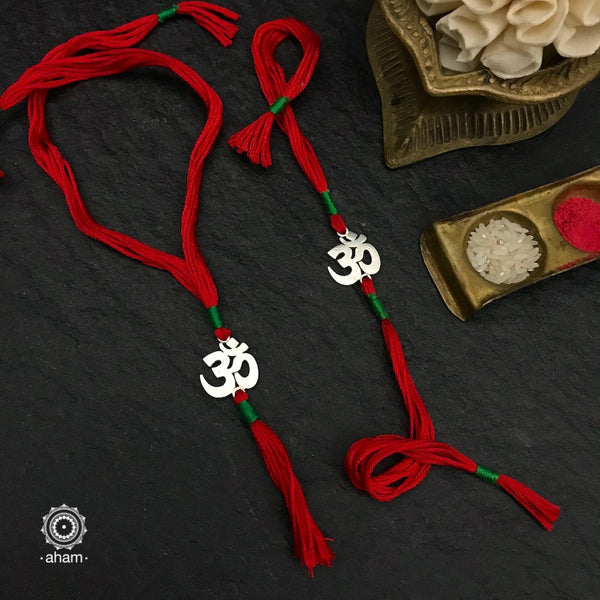 Make this Rakshabandhan Memorable with this handcrafted OM Rakhi Lumba set crafted in 925 Silver and weaved with cotton thread.   Roli (kumkum), Akshat (Chawal) and Mishri shipped along with India orders only  Tip: you can later convert this into a key chain charm or a pendant as well  Please note, Rakhi Orders will be packed and shipped in a single box only and not multiple boxes.