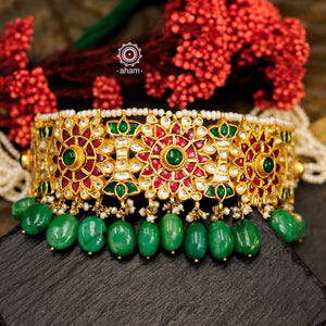 Make a sophisticated style statement this festive season with this floral choker set with semi precious green beads. Handcrafted using traditional kundan jadua techniques in 92.5 sterling silver with cultured pearls. The earrings have a intricate goddess Lakshmi motif. 